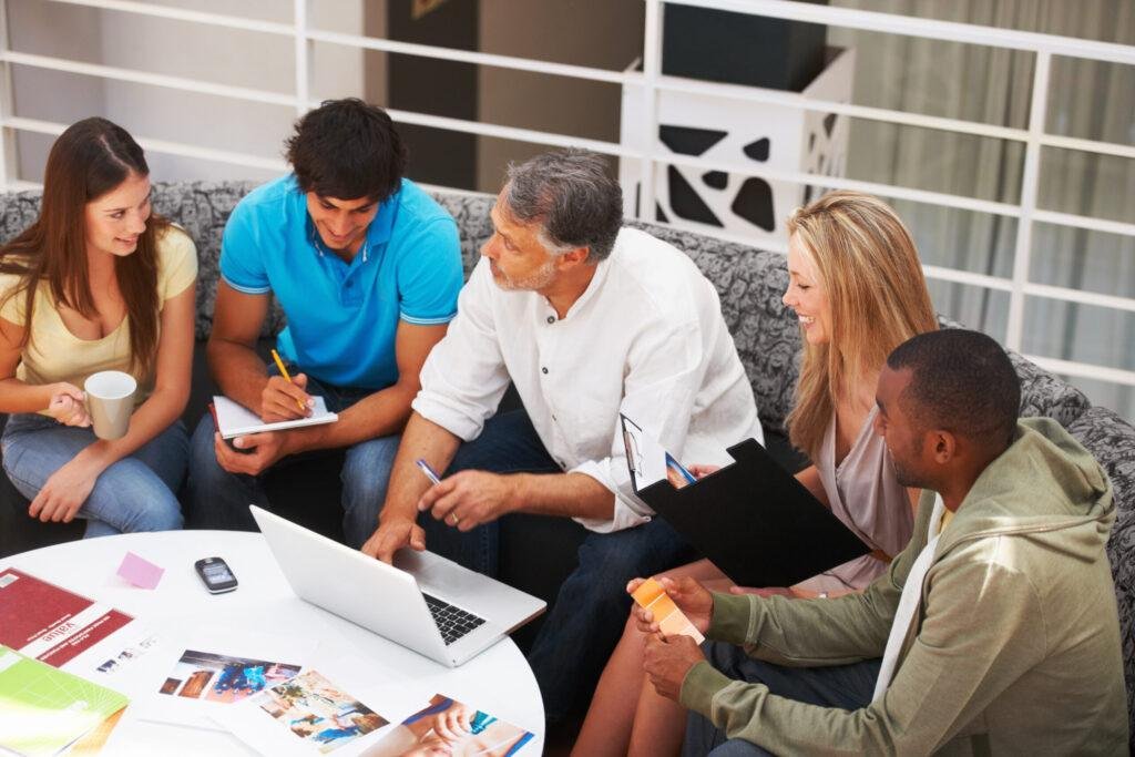 Diverse team collaborating in brainstorming session, sharing ideas on website Development