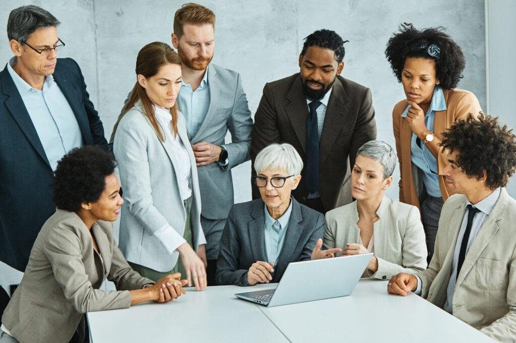 Diverse young professionals collaborating on a brand awareness campaign in modern office boardroom